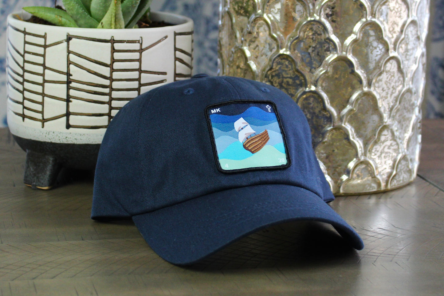 Navy adjustable hat with a Jesus calms the storm patch