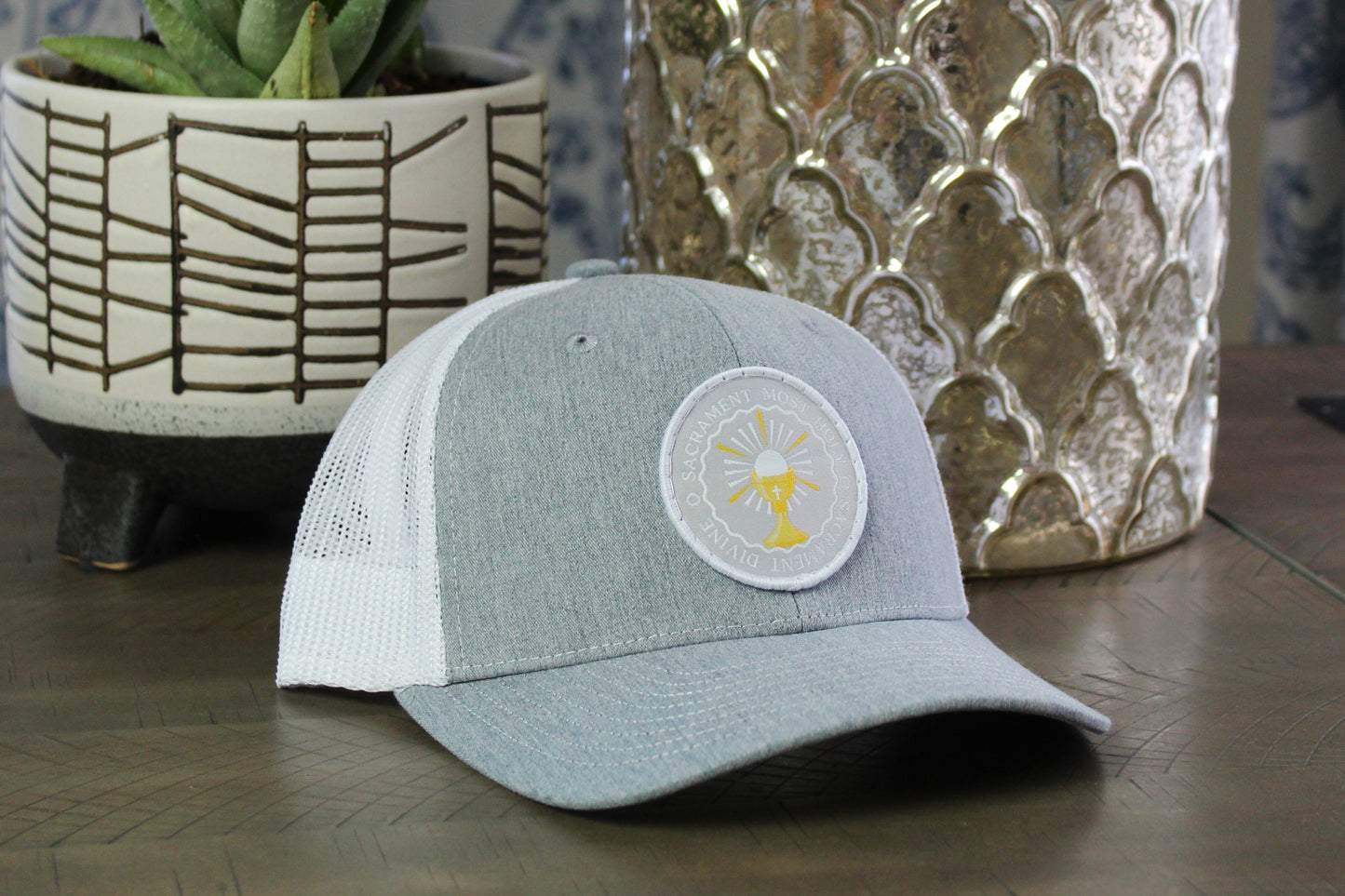 heather/gray youth snapback with an o sacrament patch