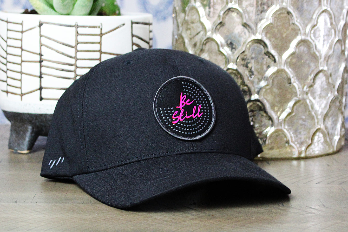 Black Flexfit Snapback with a Be Still Patch
