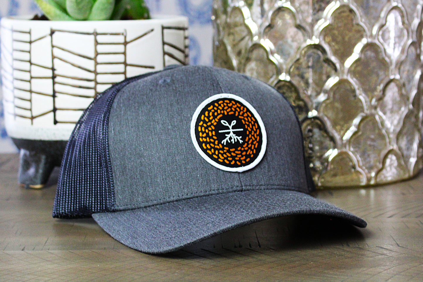 Dark heather gray/black snapback with a mustard seed patch