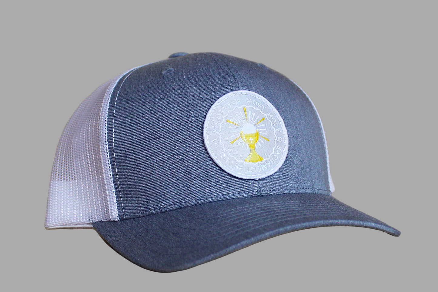 Blue and white cap with a circular logo on a wooden surface