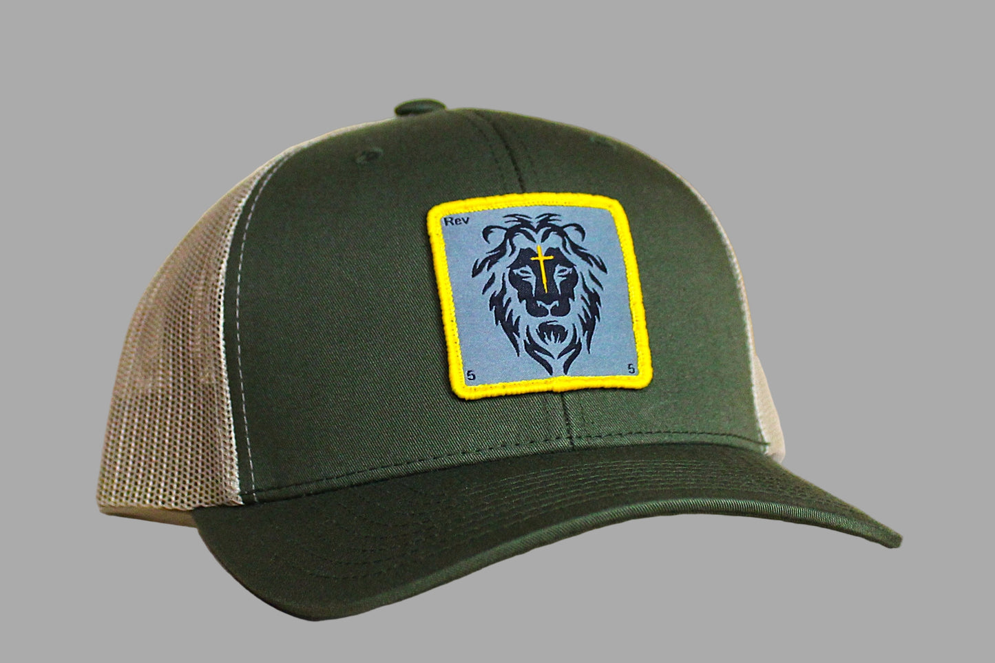 Green and brown cap with a lion emblem on a gray background