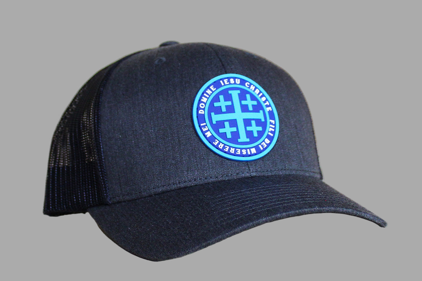 Navy blue cap with a blue circular logo on a light wooden surface
