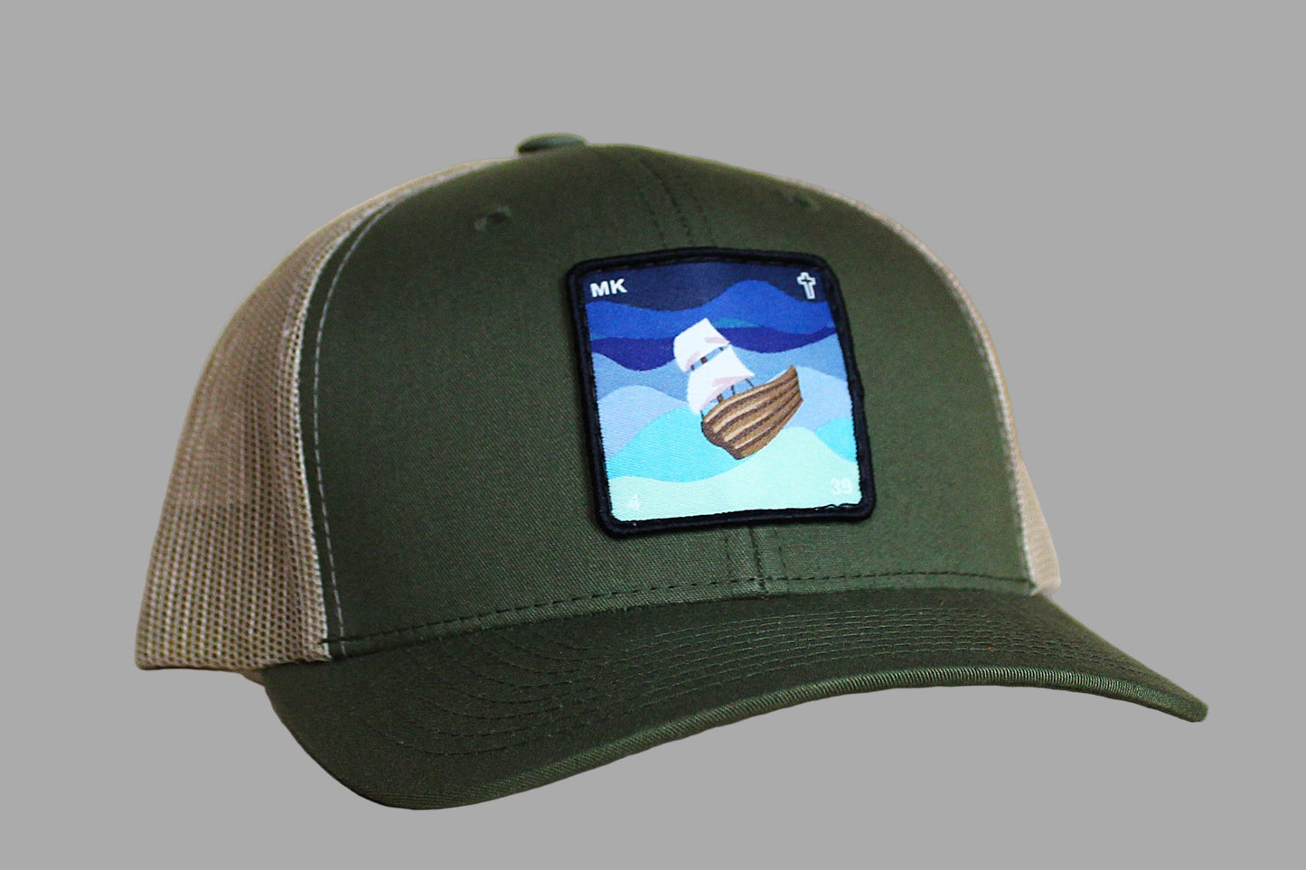 Green and brown cap with a small screen displaying an image of a boat on a gray background