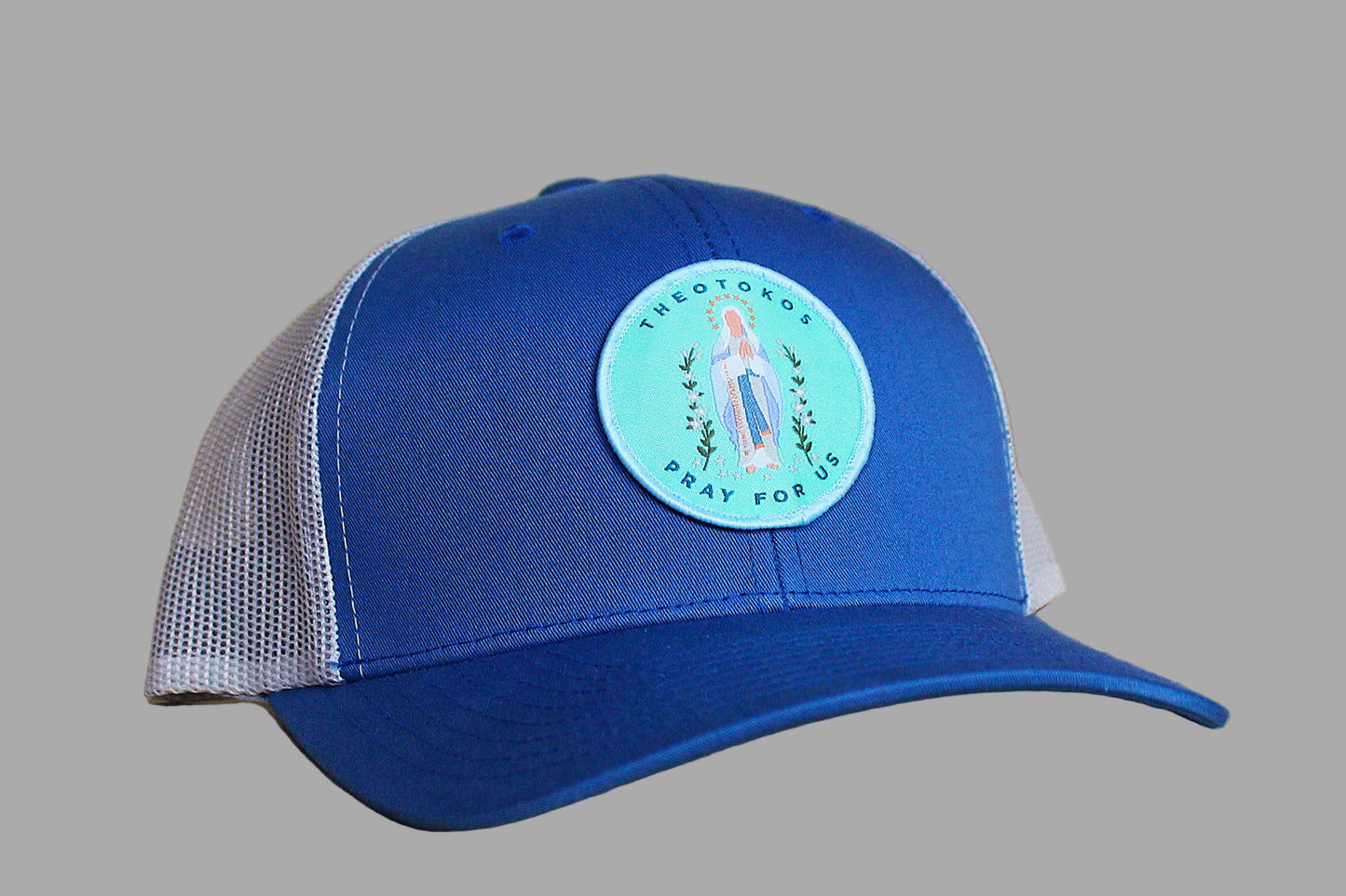 Blue cap with a circular emblem on a gray background