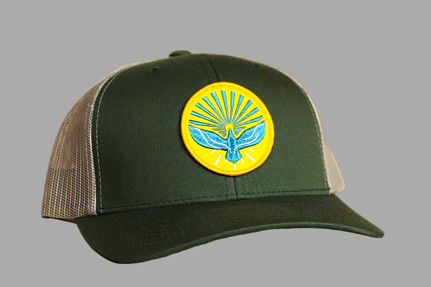 Green and brown cap with a yellow emblem featuring a blue bird design on a gray background