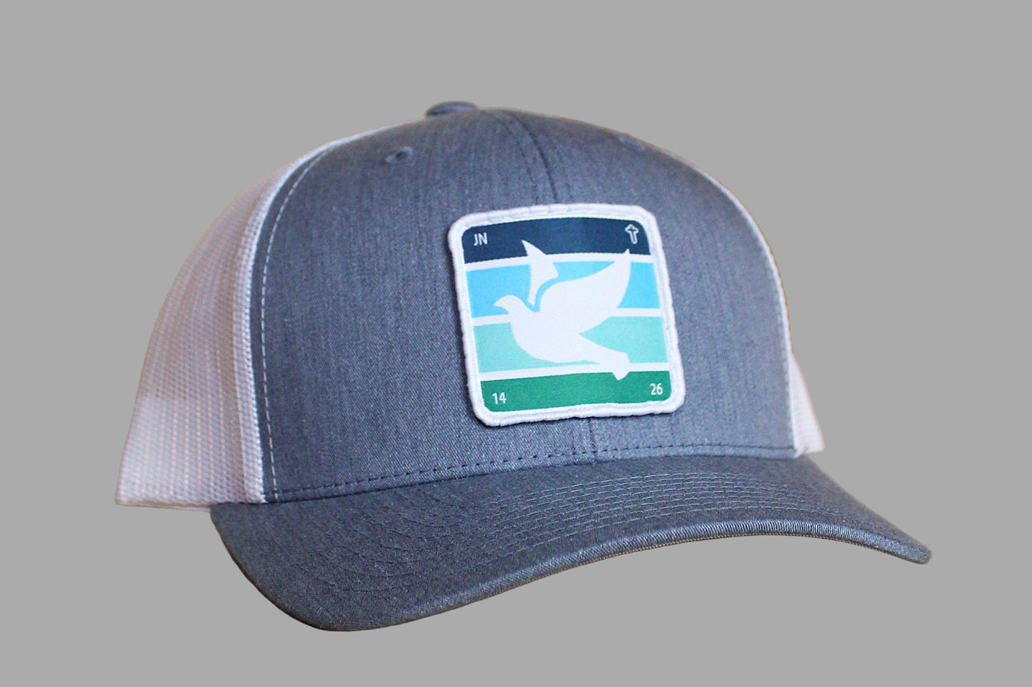 Blue and white cap with a logo on a wooden surface