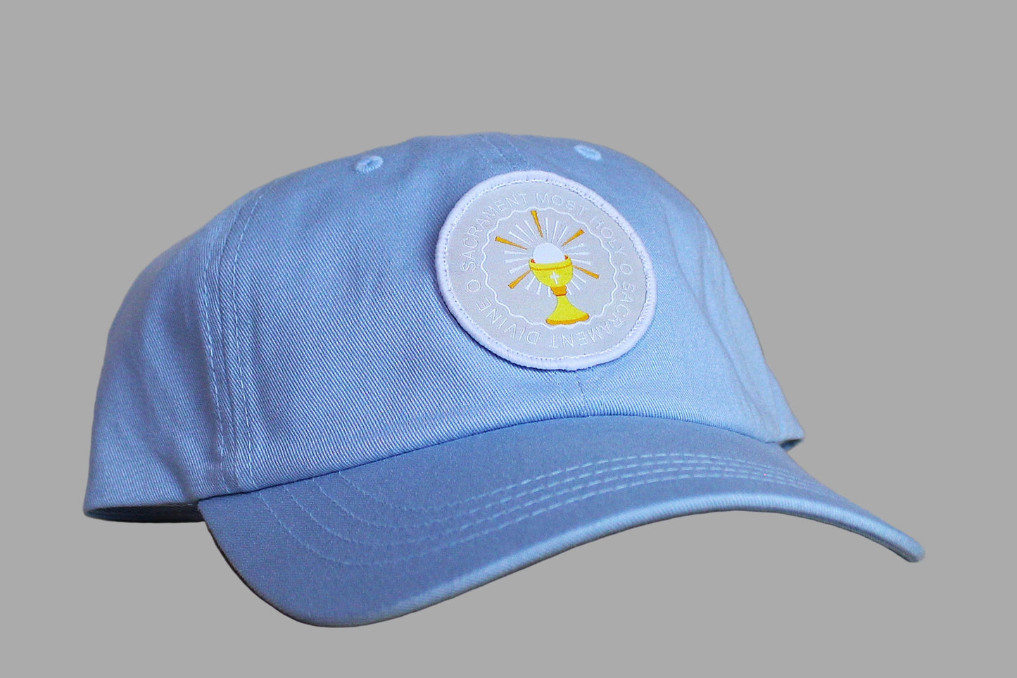 Blue cap with a circular emblem on a wooden surface