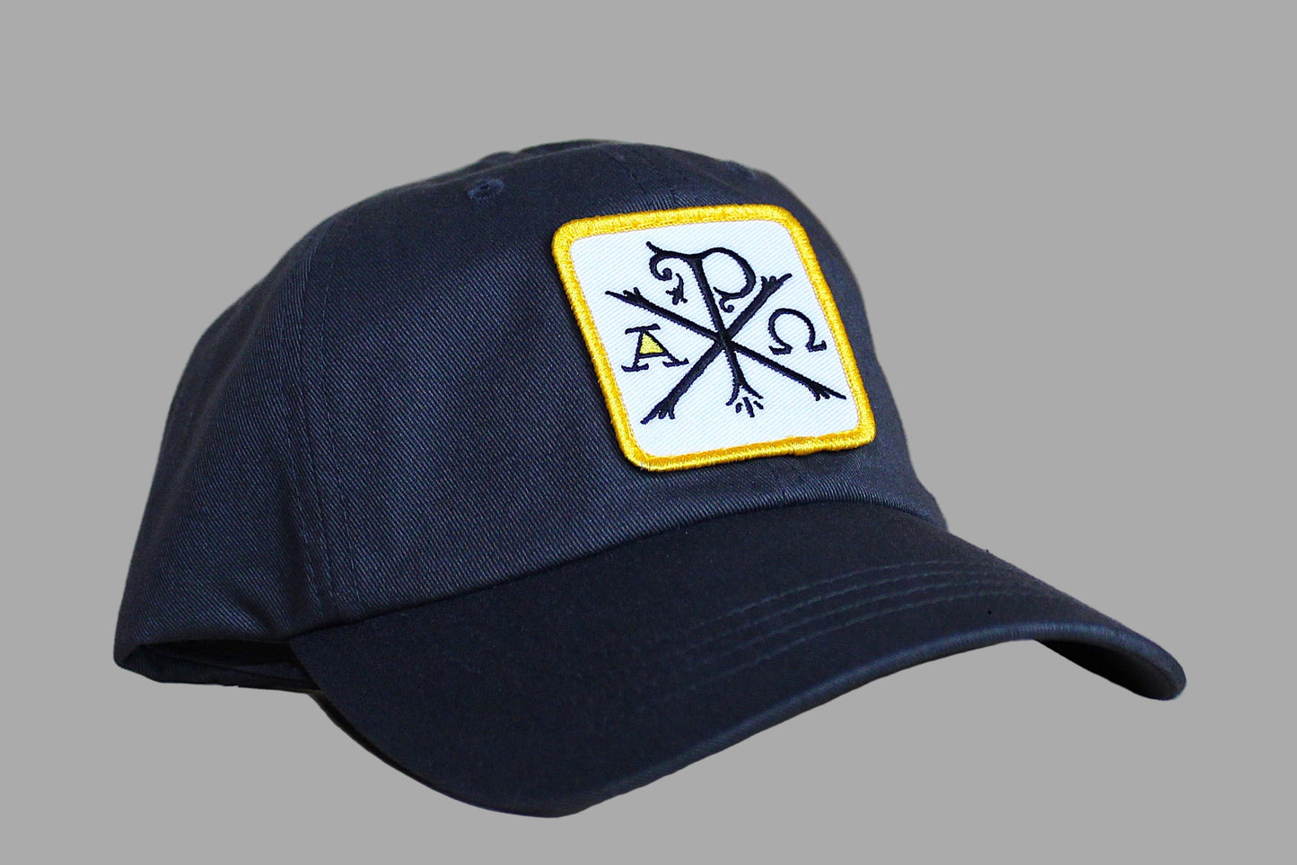 Navy blue cap with a logo on a wooden surface
