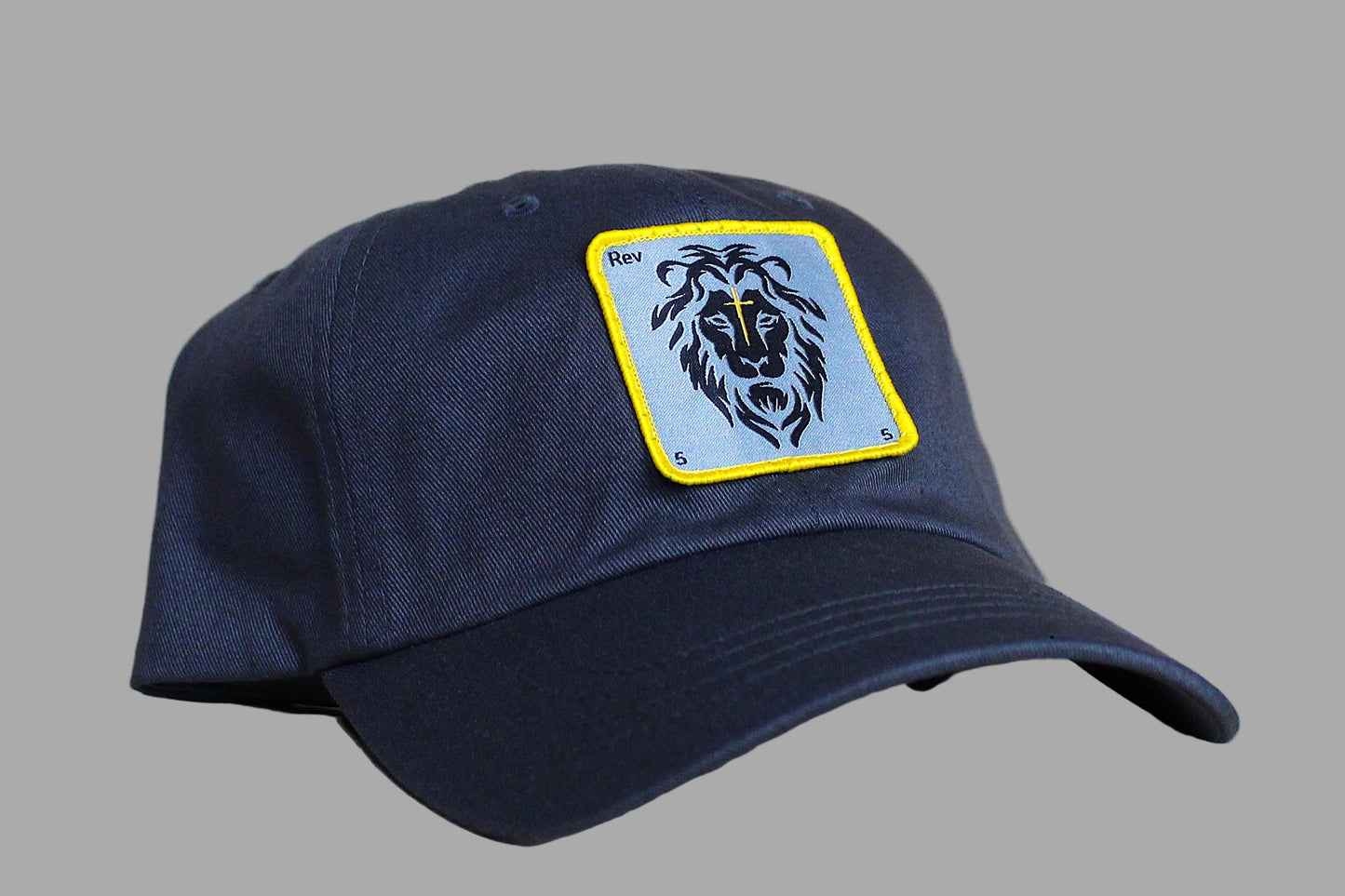 Navy blue cap with a lion emblem patch on a light wooden surface