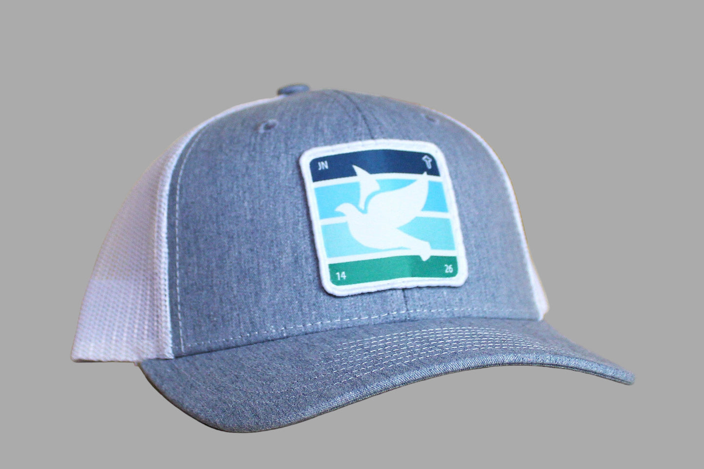 Blue cap with a logo on a wooden surface