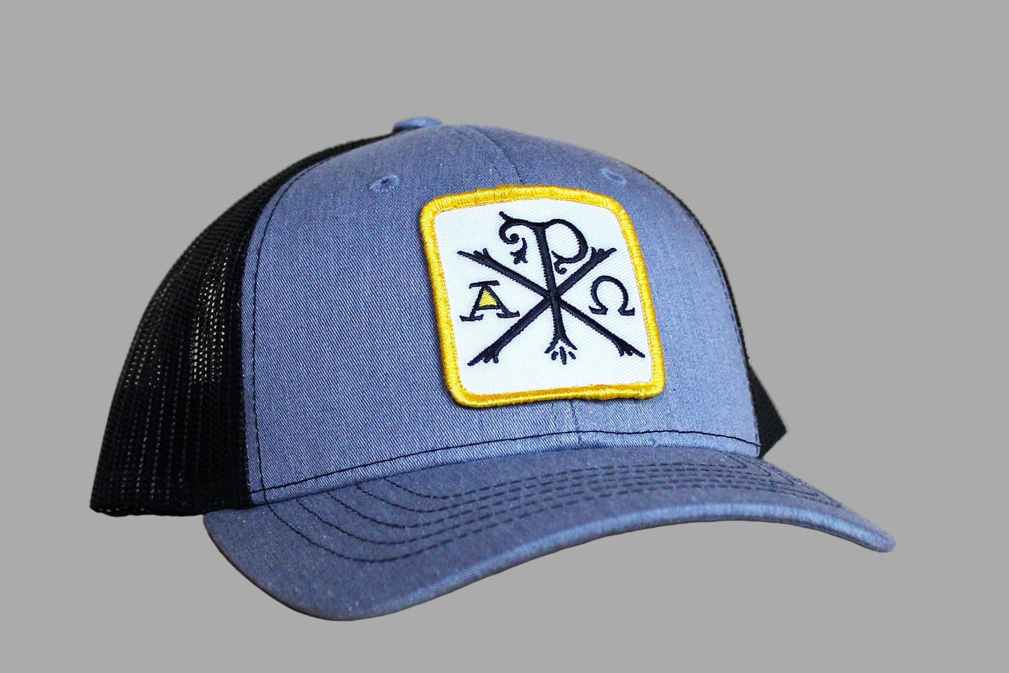 Blue and black cap with a logo on a wooden surface
