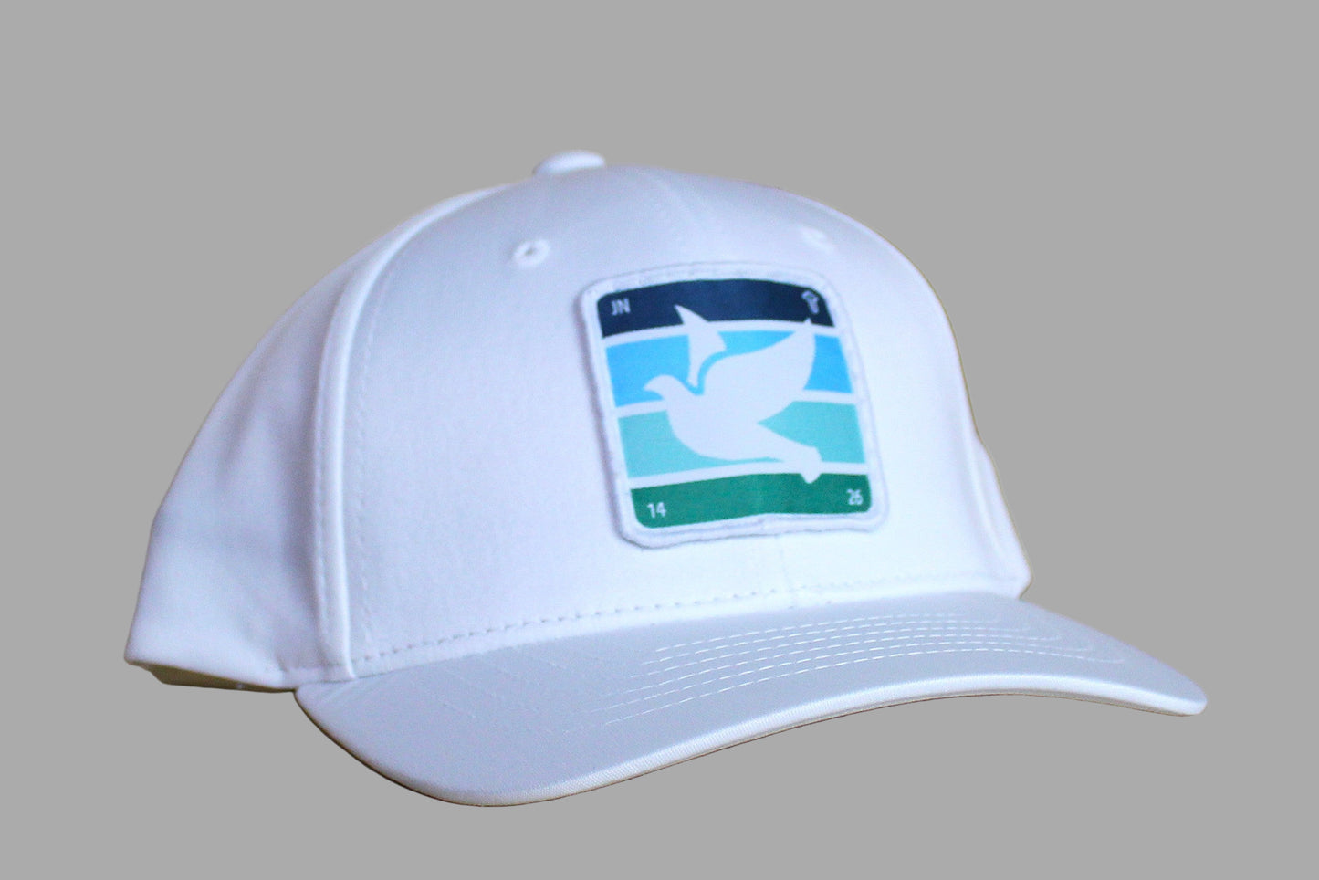 White cap with a logo on a wooden surface