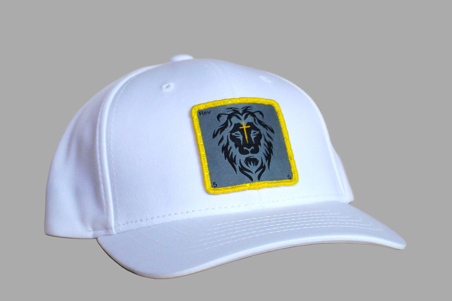 White cap with a lion emblem on a wooden surface