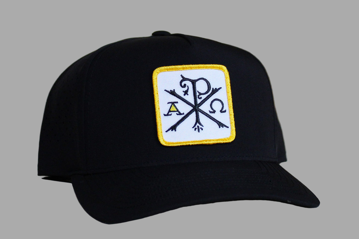 Black cap with a logo on a light wooden surface