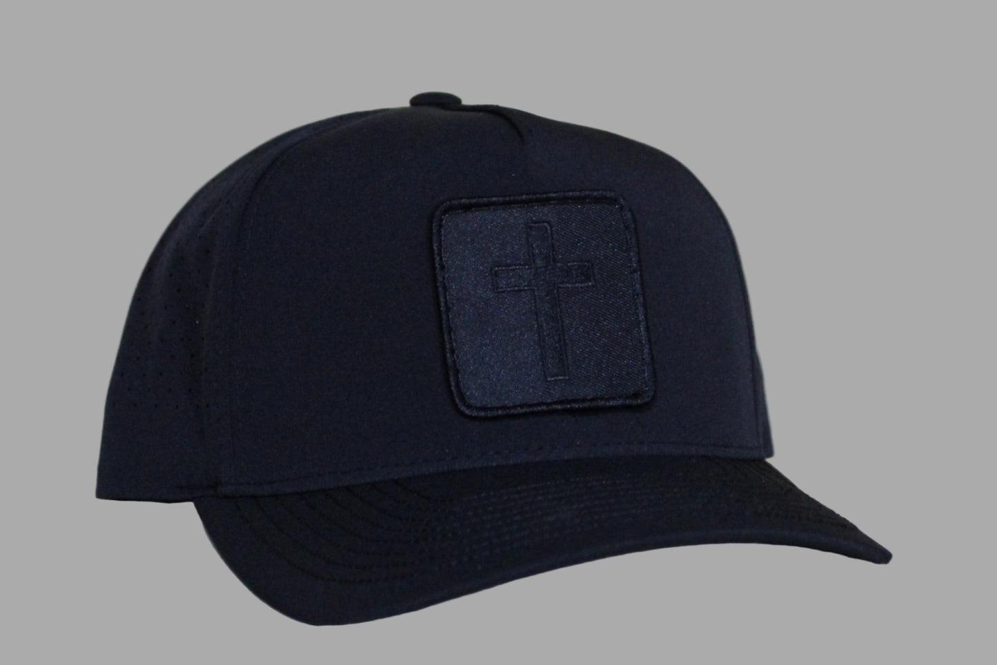 Black cap with a logo patch on a light background