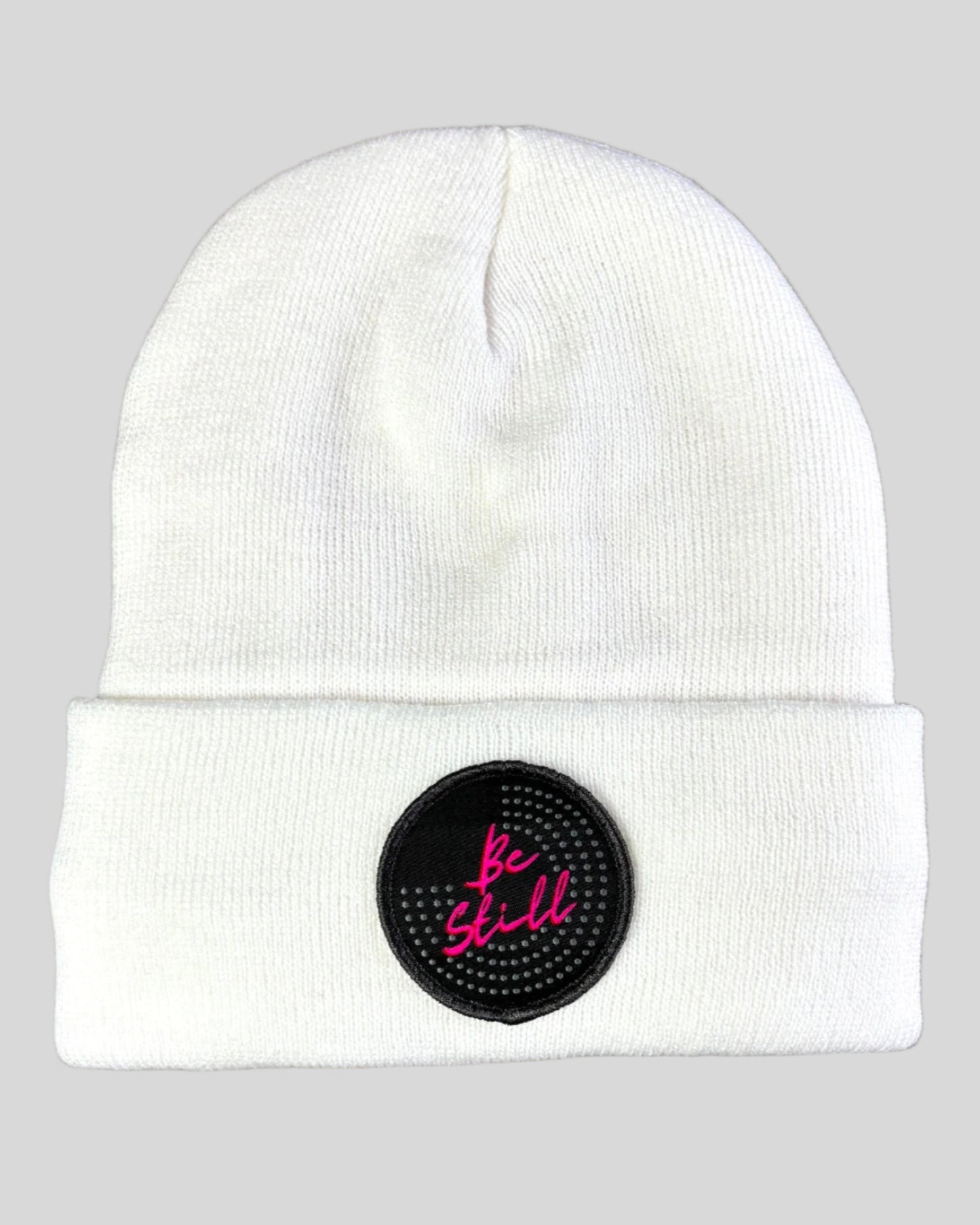 White winter hat with a Be Still patch