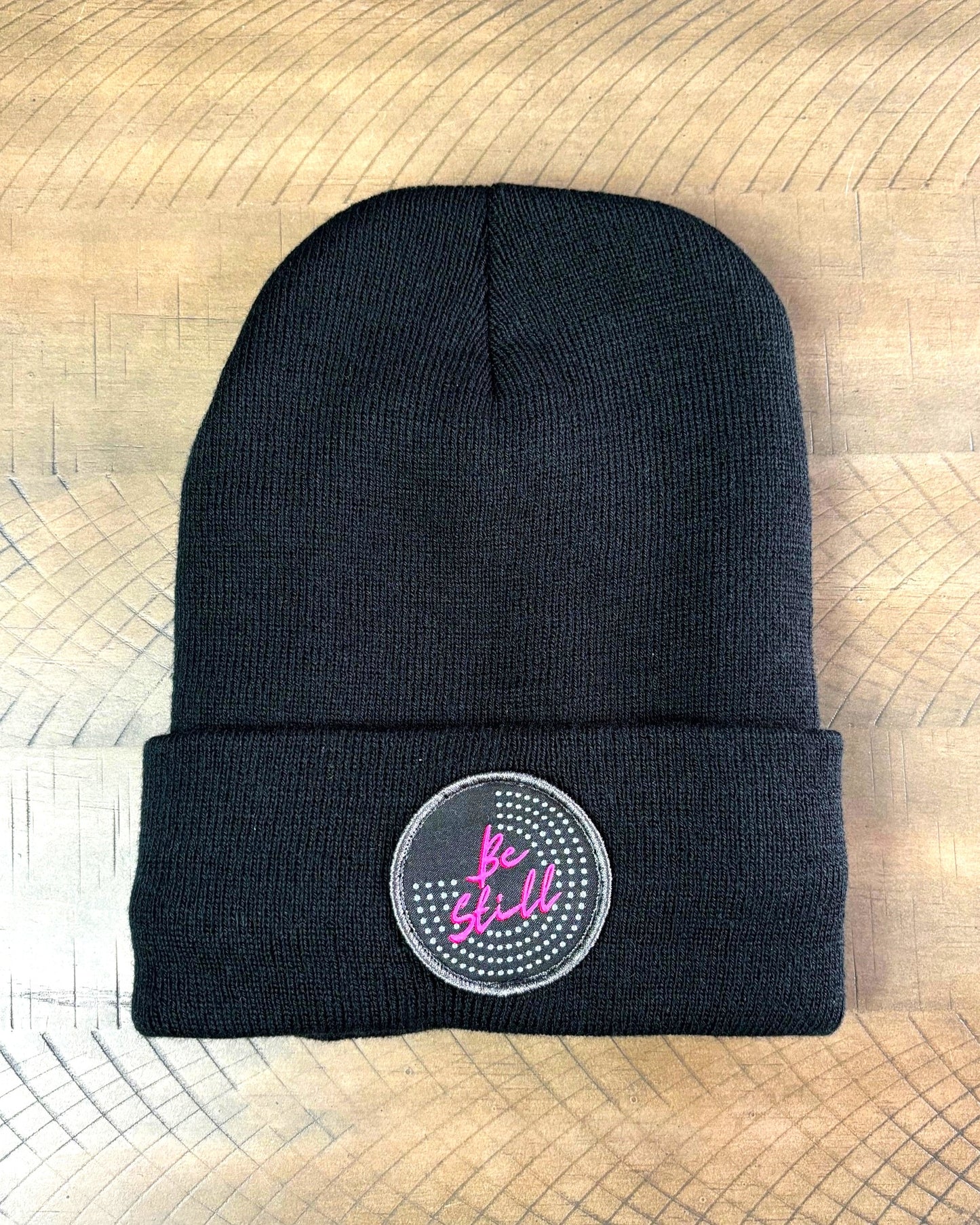 Black winter hat with a Be Still patch