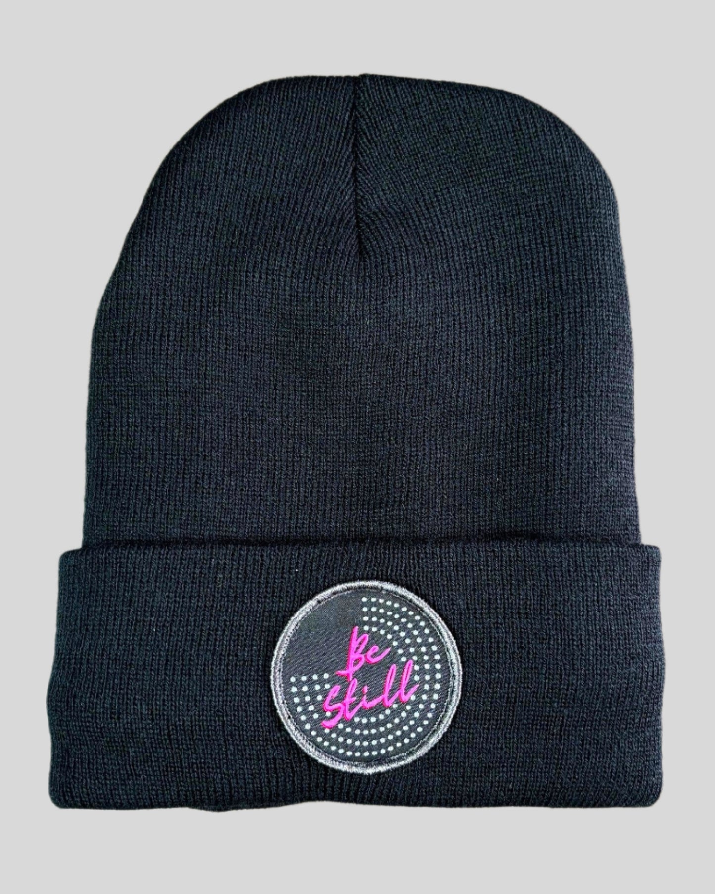 Black winter hat with a Be Still patch