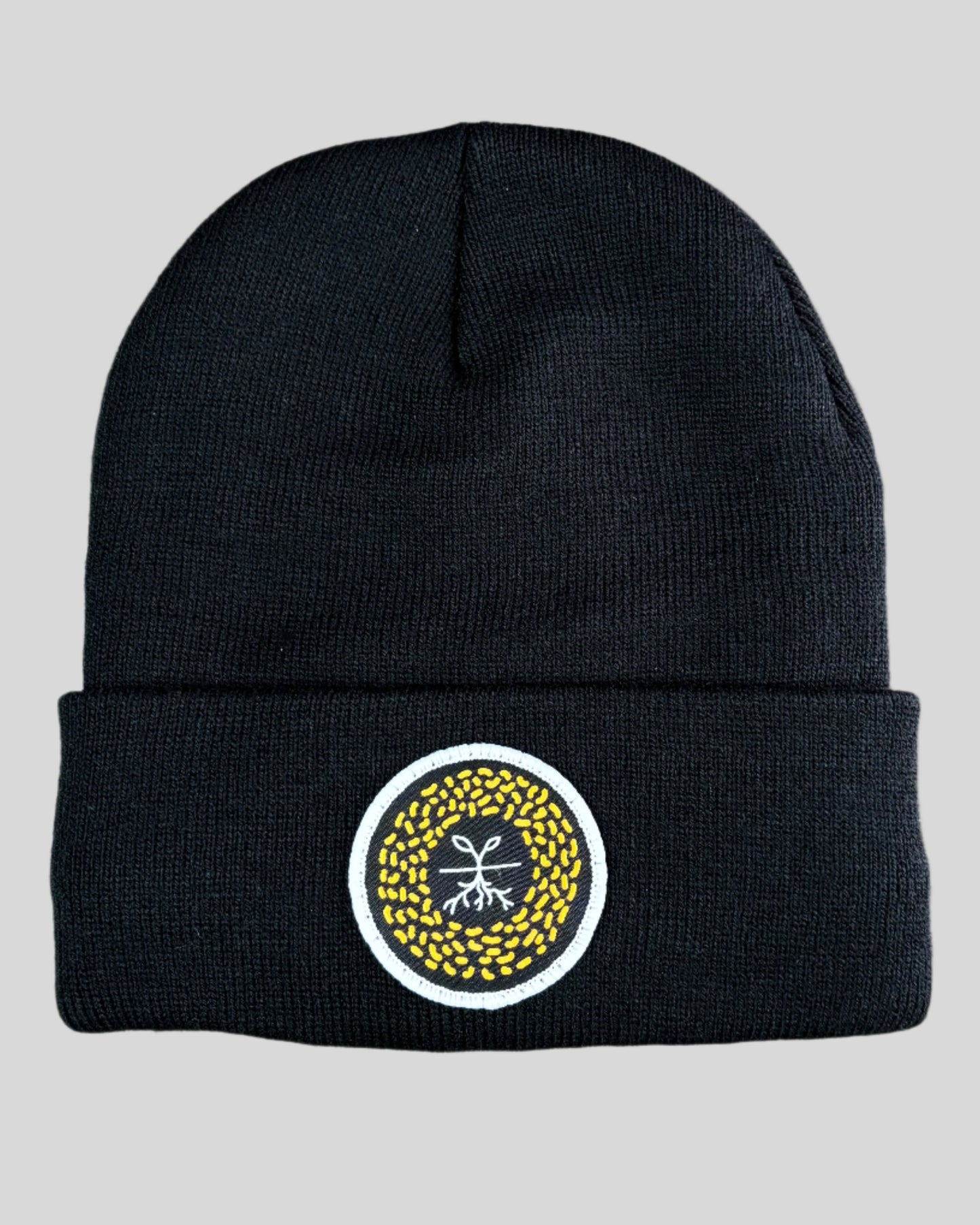 Black winter hat with a mustard seed patch