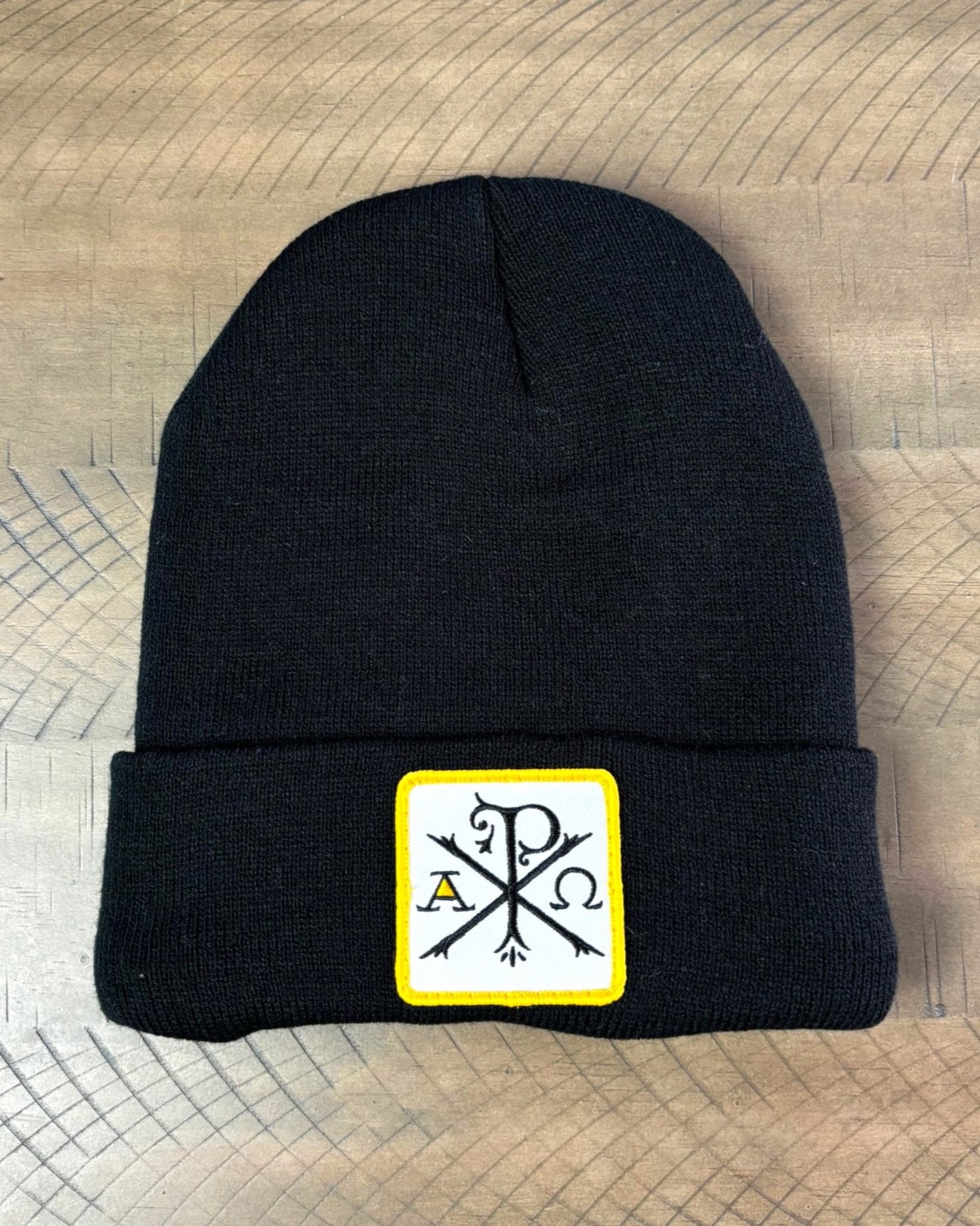 Black winter hat with a chi-rho patch