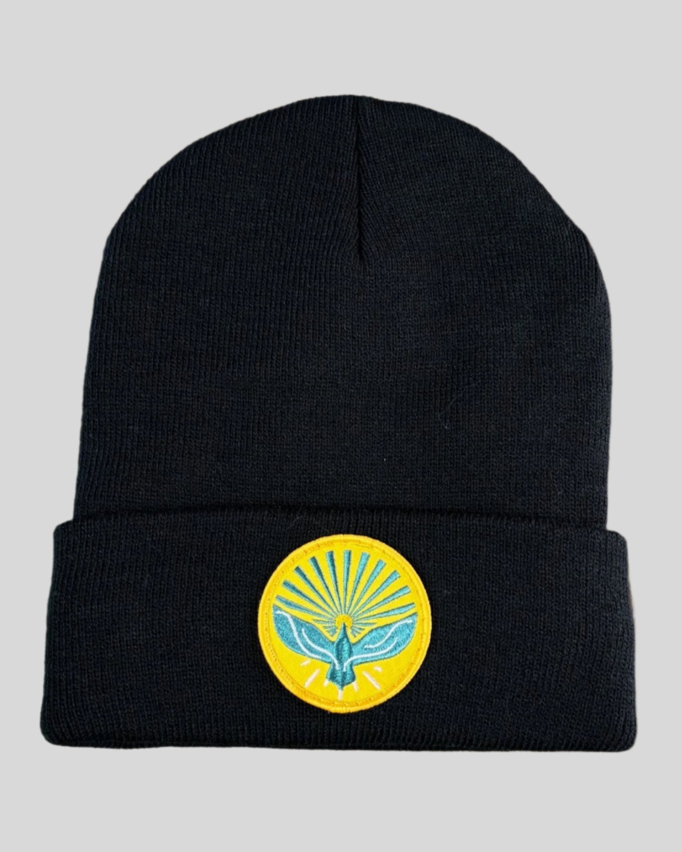 Black winter hat with a pentecost patch