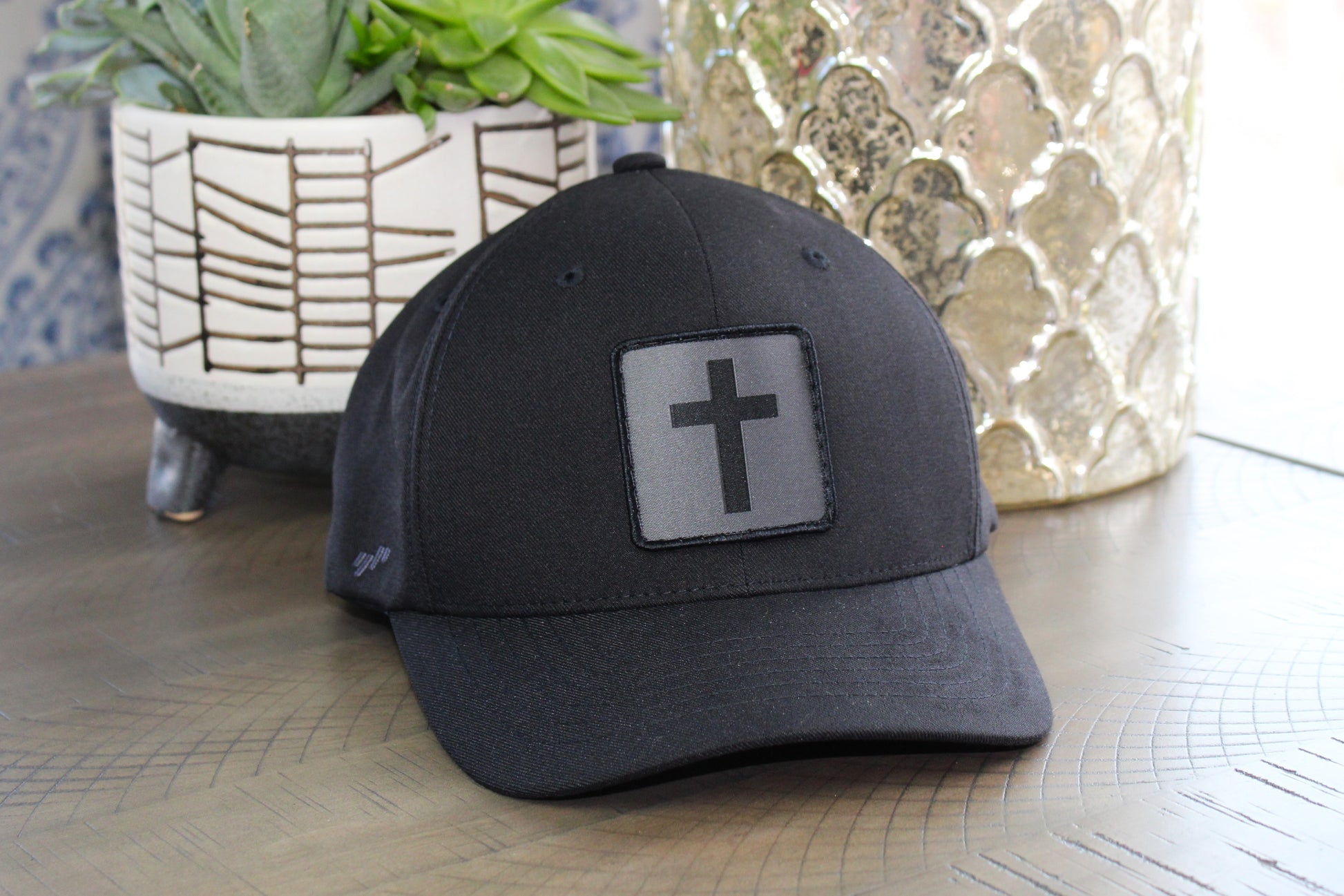 Black Flexfit with a humble threads cross patch