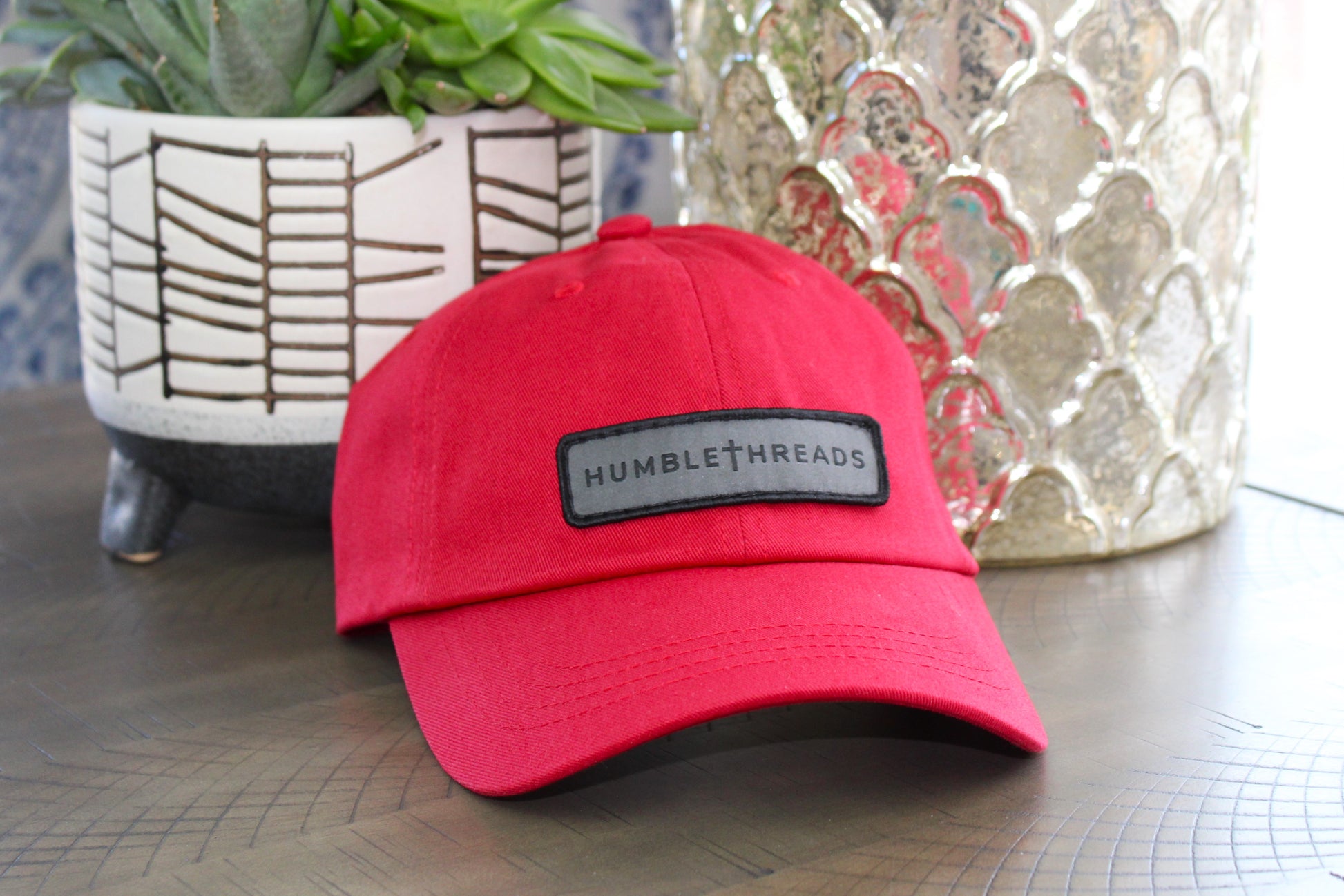 Red adjustable hat with a humble threads patch