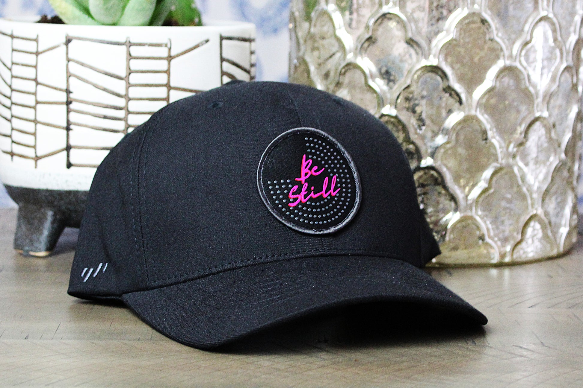 Black Flexfit Snapback with a Be Still Patch