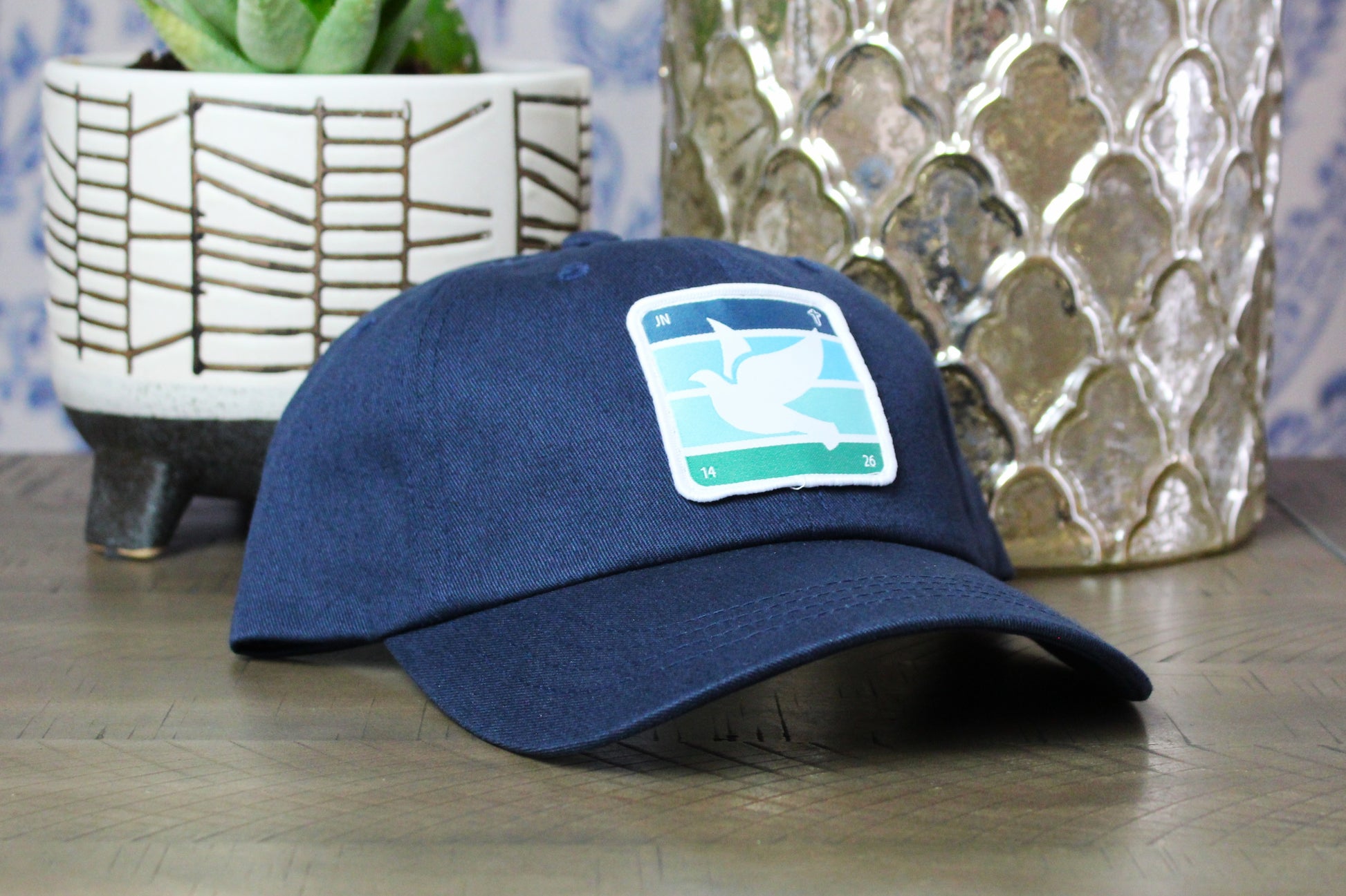 Navy adjustable hat with a holy spirt dove patch