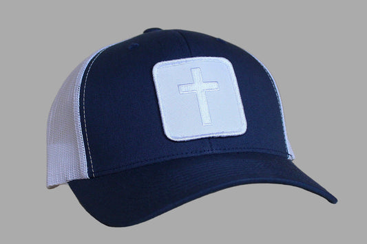 Navy blue cap with a white cross patch on a gray background