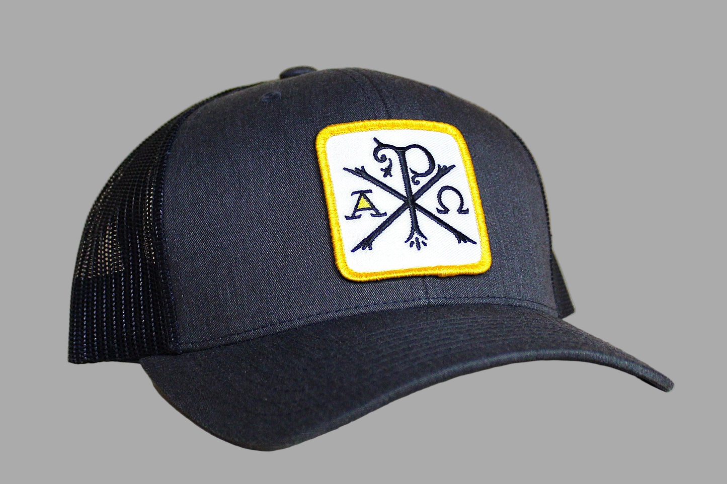 Black cap with a white patch featuring symbols on a gray background