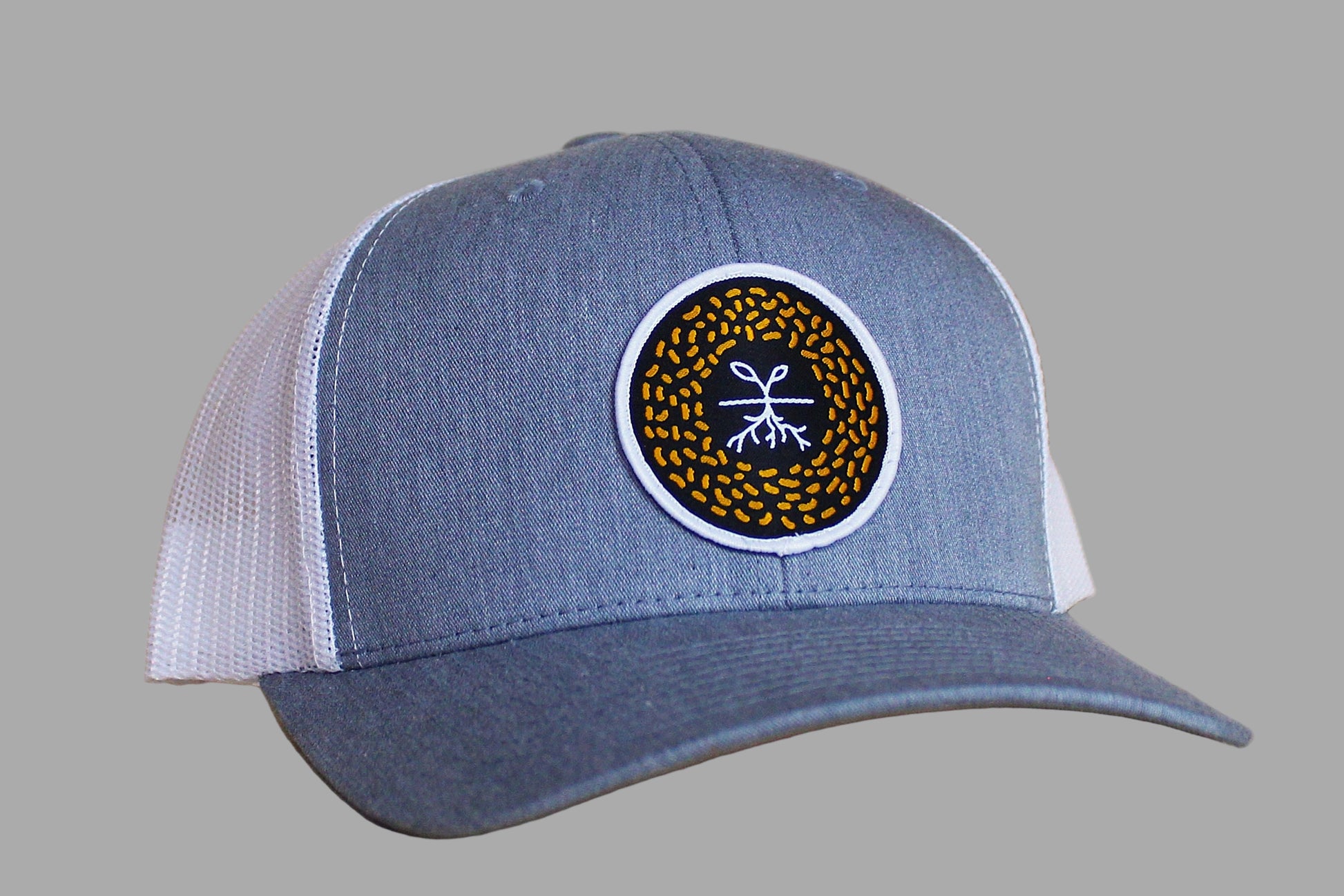 Blue and white cap with a circular logo on a gray background
