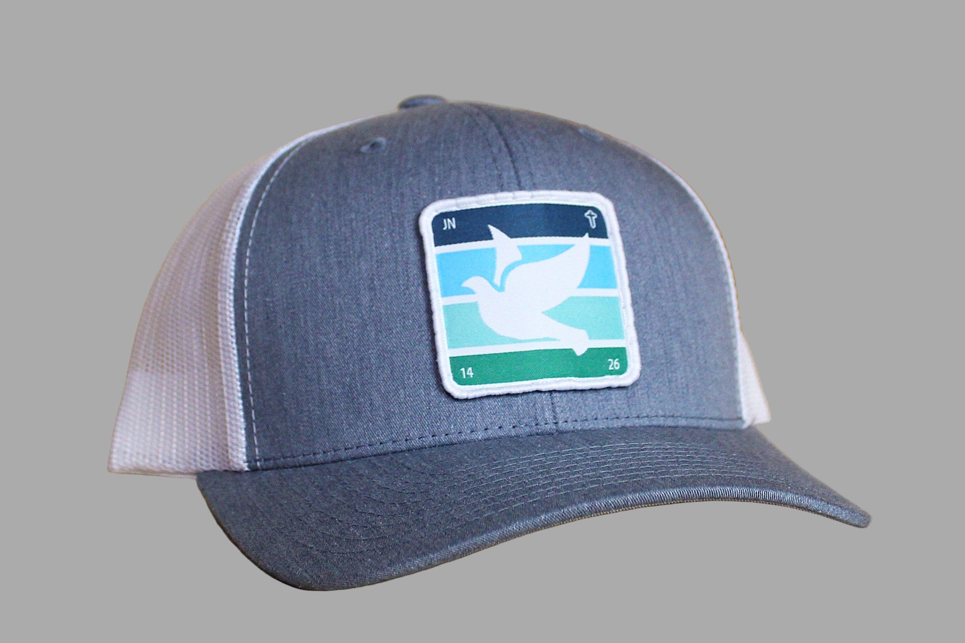 Blue and white cap with a logo on a wooden surface