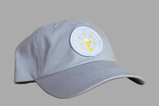 Gray cap with a white patch featuring a yellow logo on a wooden surface