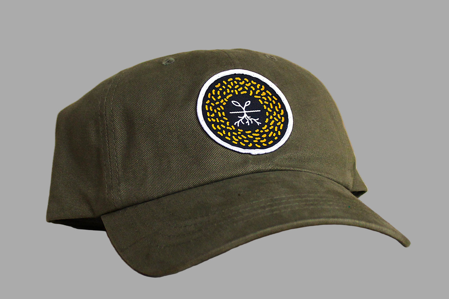 Green cap with a circular logo on a wooden surface