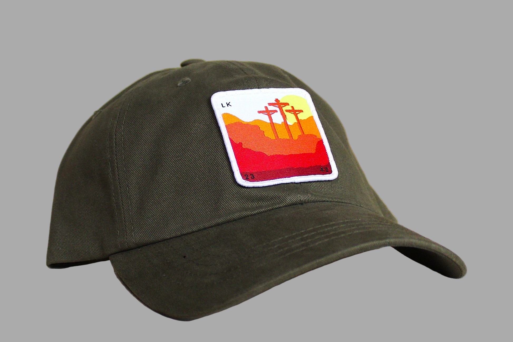 Green cap with a colorful patch on a wooden surface