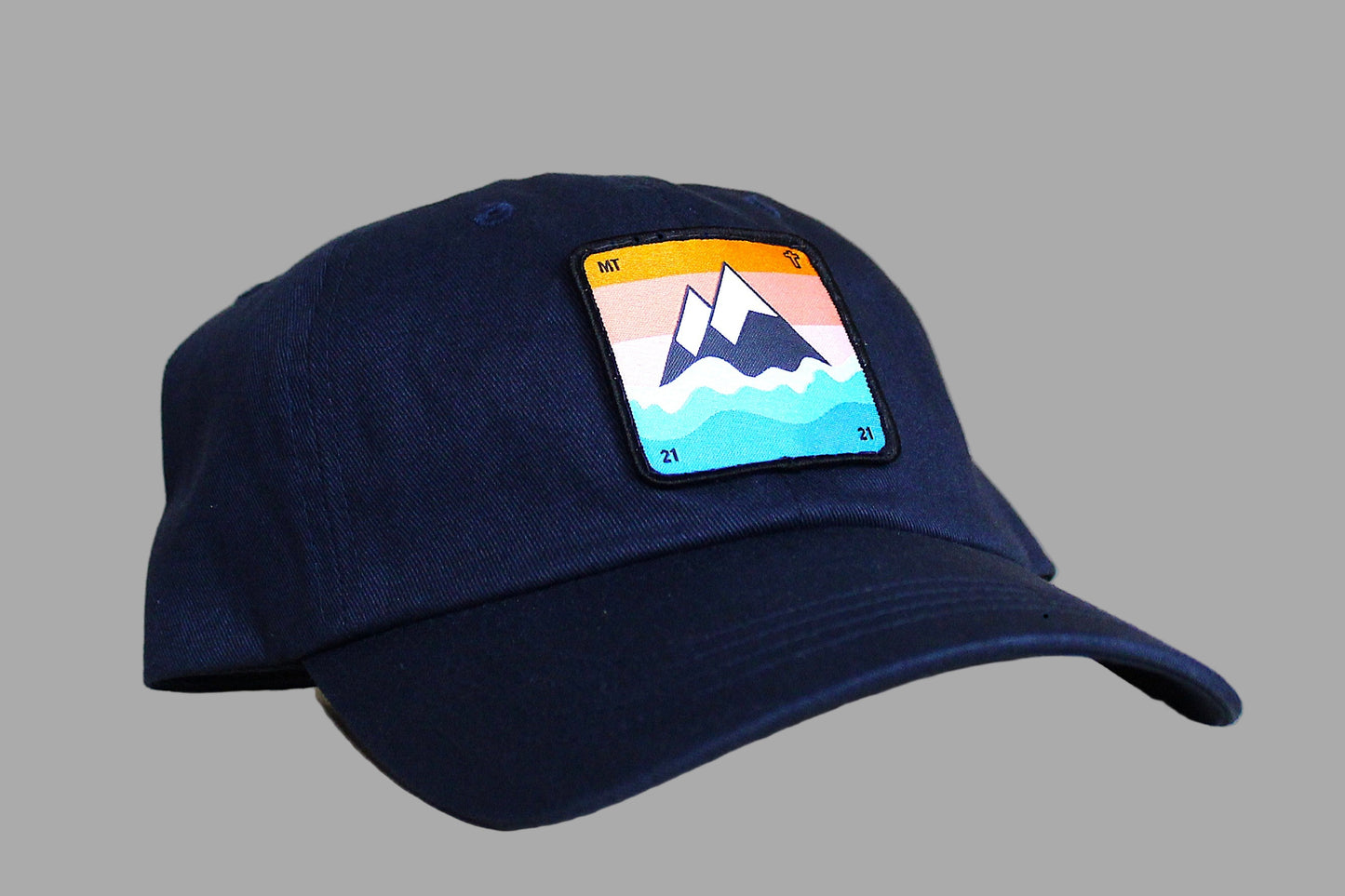 Navy blue cap with a mountain logo on a gray background