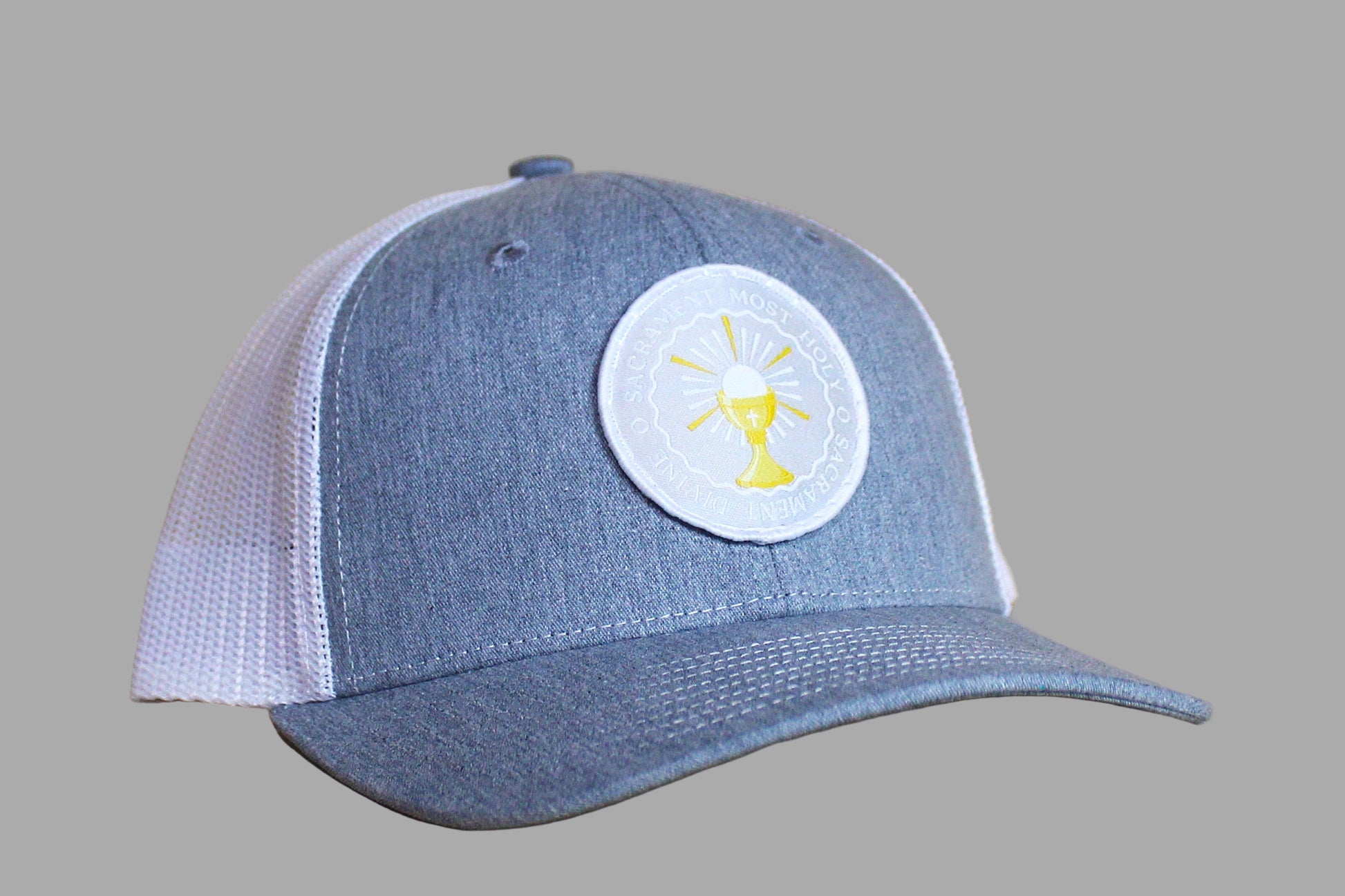 Blue and white cap with a circular logo on a wooden surface