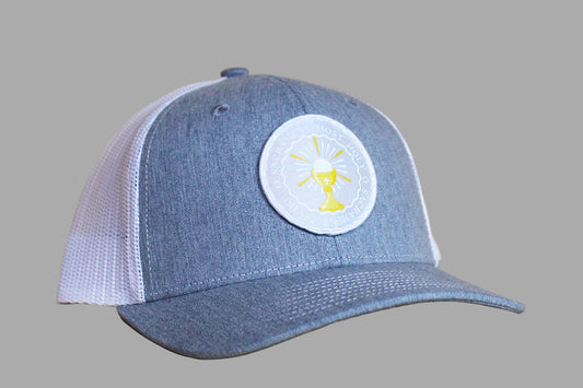 Blue and white cap with a circular logo on a wooden surface