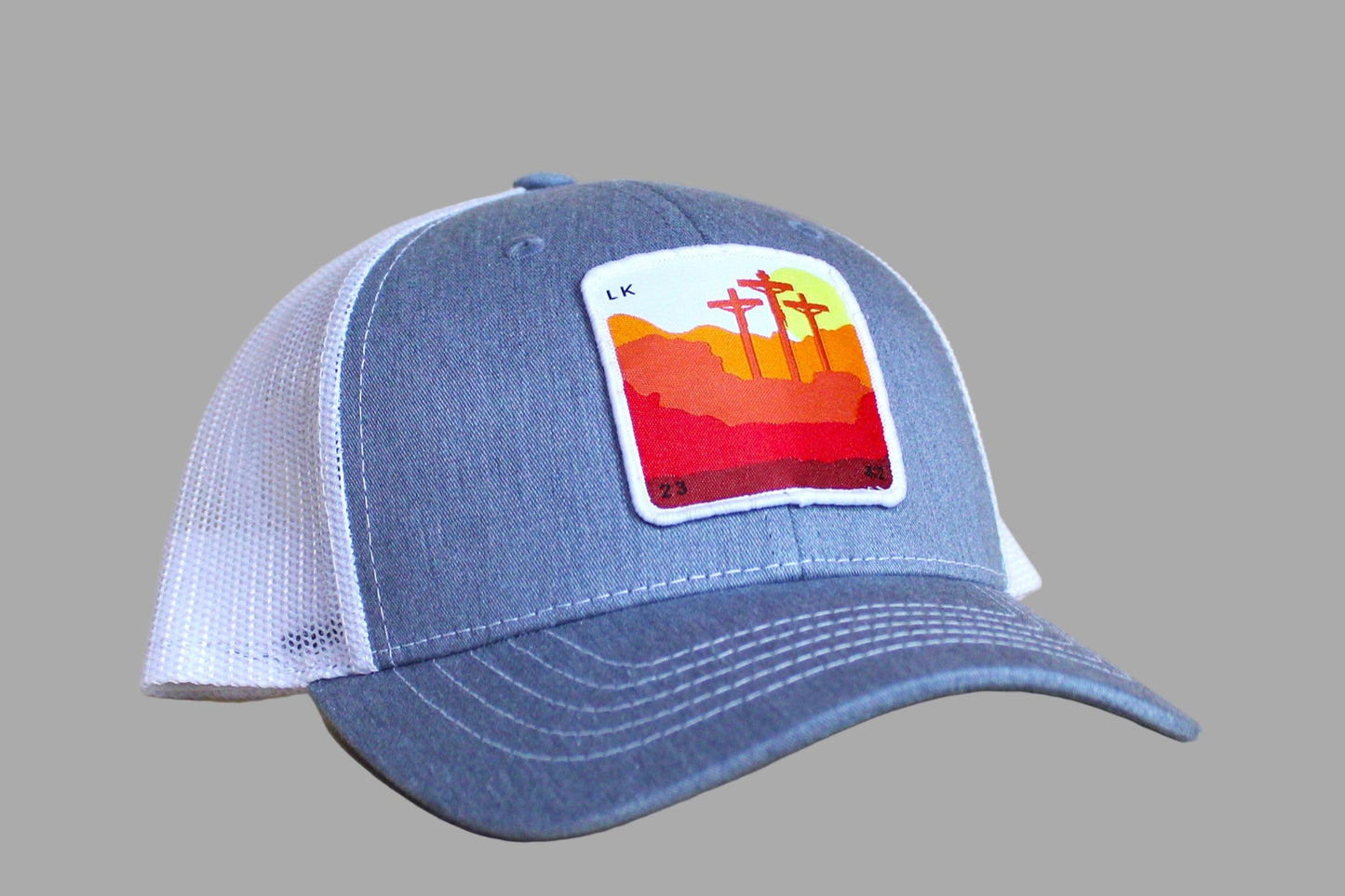 Blue cap with a colorful patch on a wooden surface