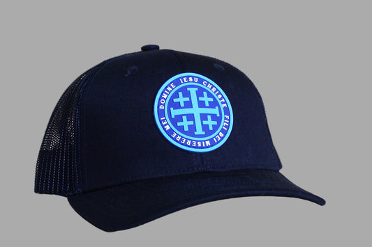 Black cap with a blue logo on a light wooden surface