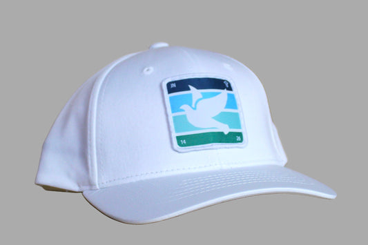 White cap with a logo on a wooden surface