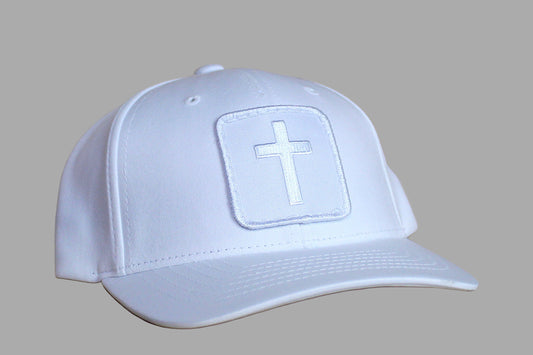 White cap with a cross emblem on a wooden surface