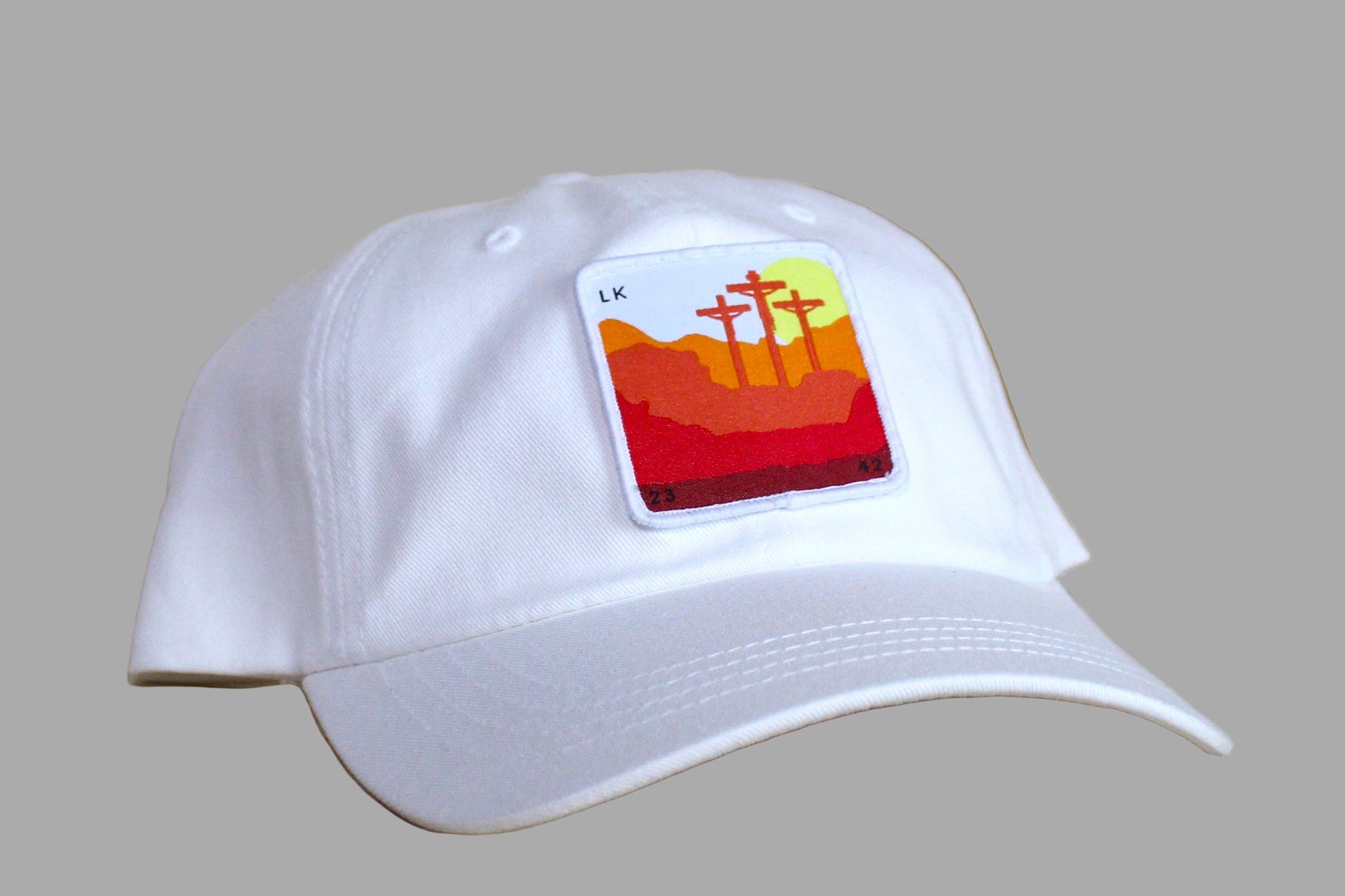 White cap with a colorful patch on a wooden surface