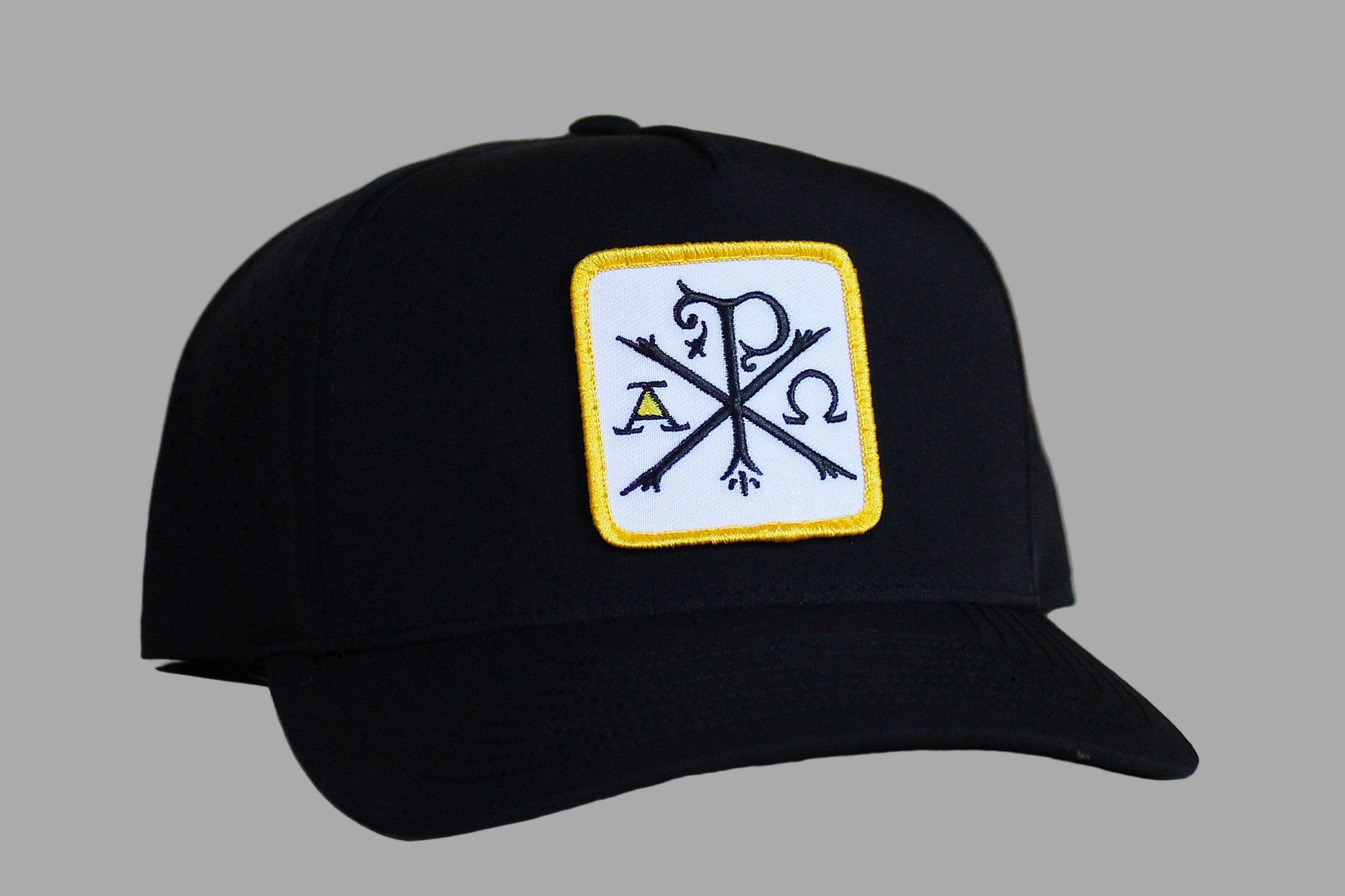 Black cap with a logo on a light wooden surface
