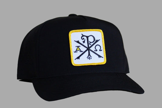 Black cap with a logo on a light wooden surface