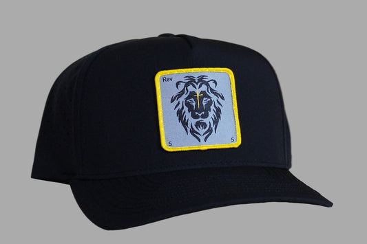 Black cap with a lion emblem patch on a light wooden surface