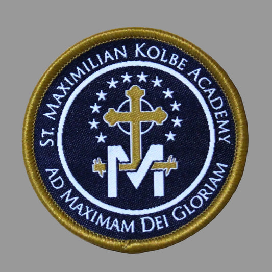 Patch with 'St. Maximilian Kolbe Academy' text and cross design on a beige background